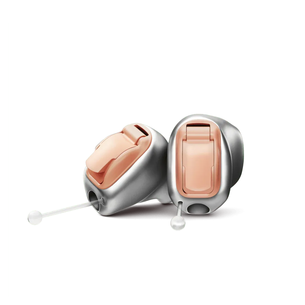 Two custom-made Phonak Infinio Virto-10 in-the-ear hearing aids, silver-grey shells with salmon faceplates, battery drawer and clear removal wire