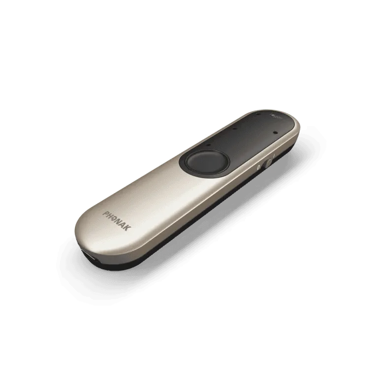 Elongated champagne-toned microphone with a black top and a round button in the middle, seen at an angle.