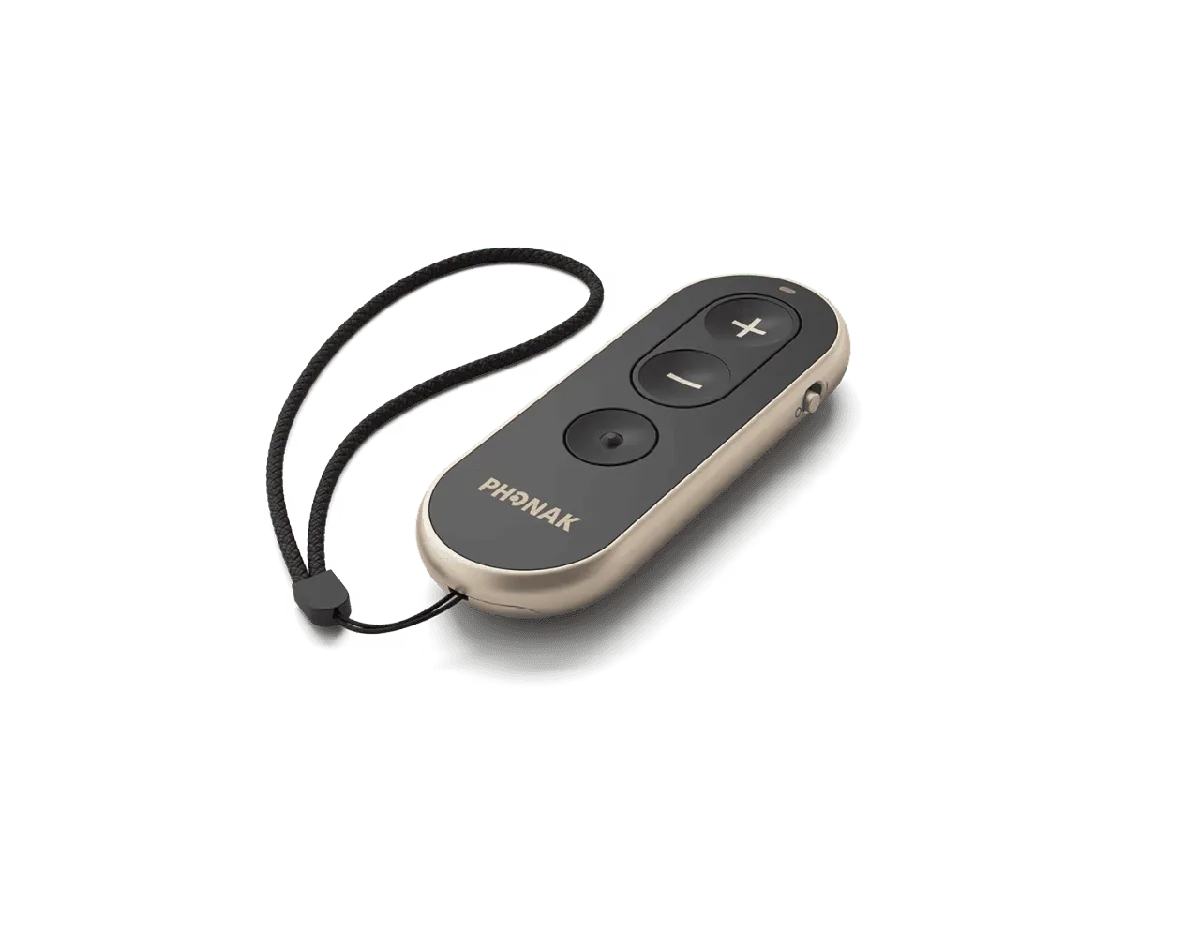 Elongated champagne-toned remote with plus and minus buttons, a central button and a black wrist cord attached at the top.