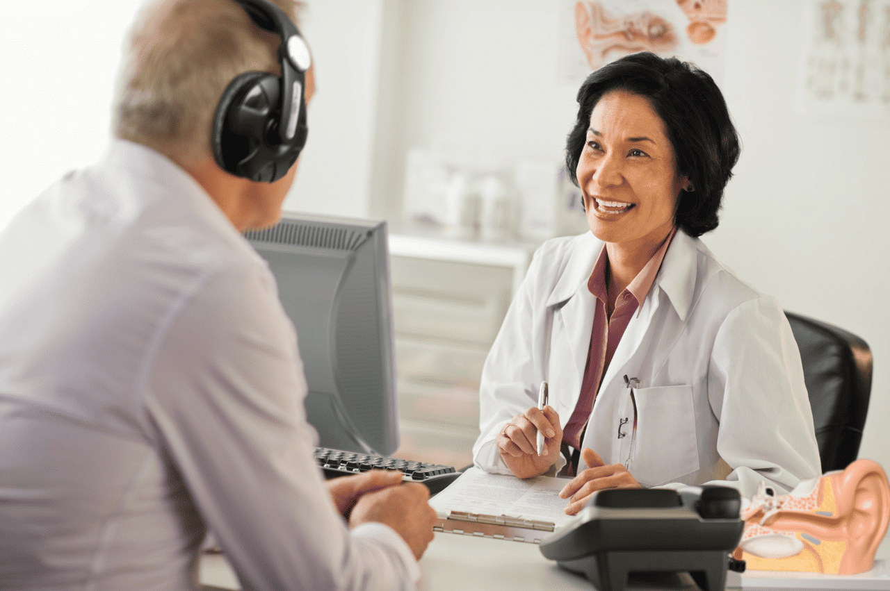 female audiologist talking to patient